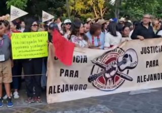 Familiares de periodista Leyva protestan en desfile de delegaciones en exigencia de justicia; grupo de choque intentó bloquearlos, denuncian